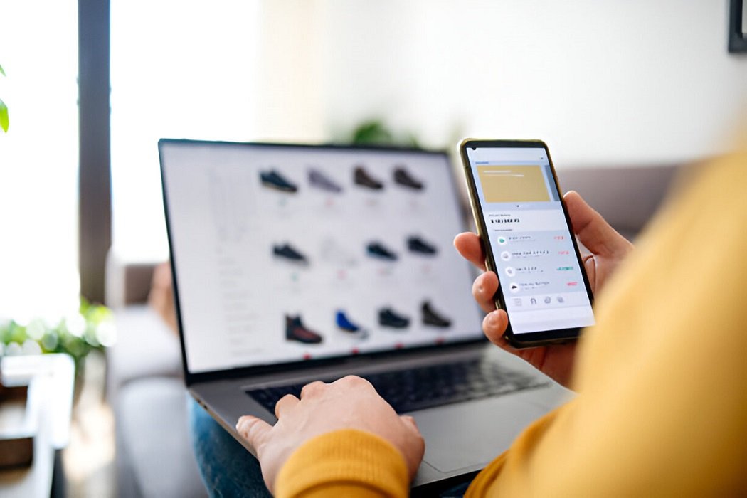 A young person browsing Gumtree on a laptop, with items listed for sale displayed on the screen.