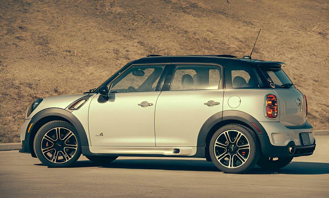 "2024 MINI Countryman in British Racing Green with modern design and cityscape background."